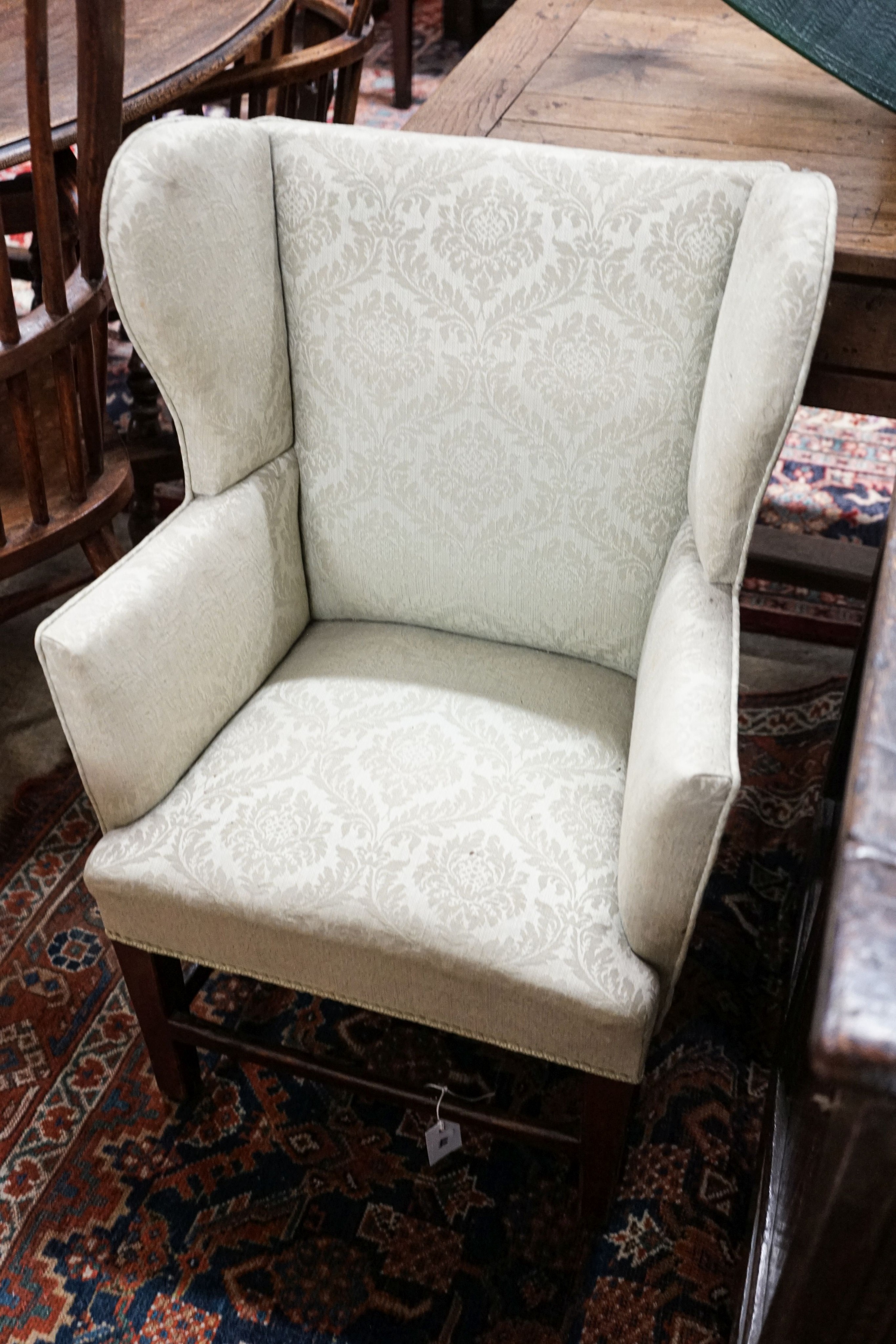 A George III oak child's upholstered wing armchair, width 52cm, depth 41cm, height 84cm